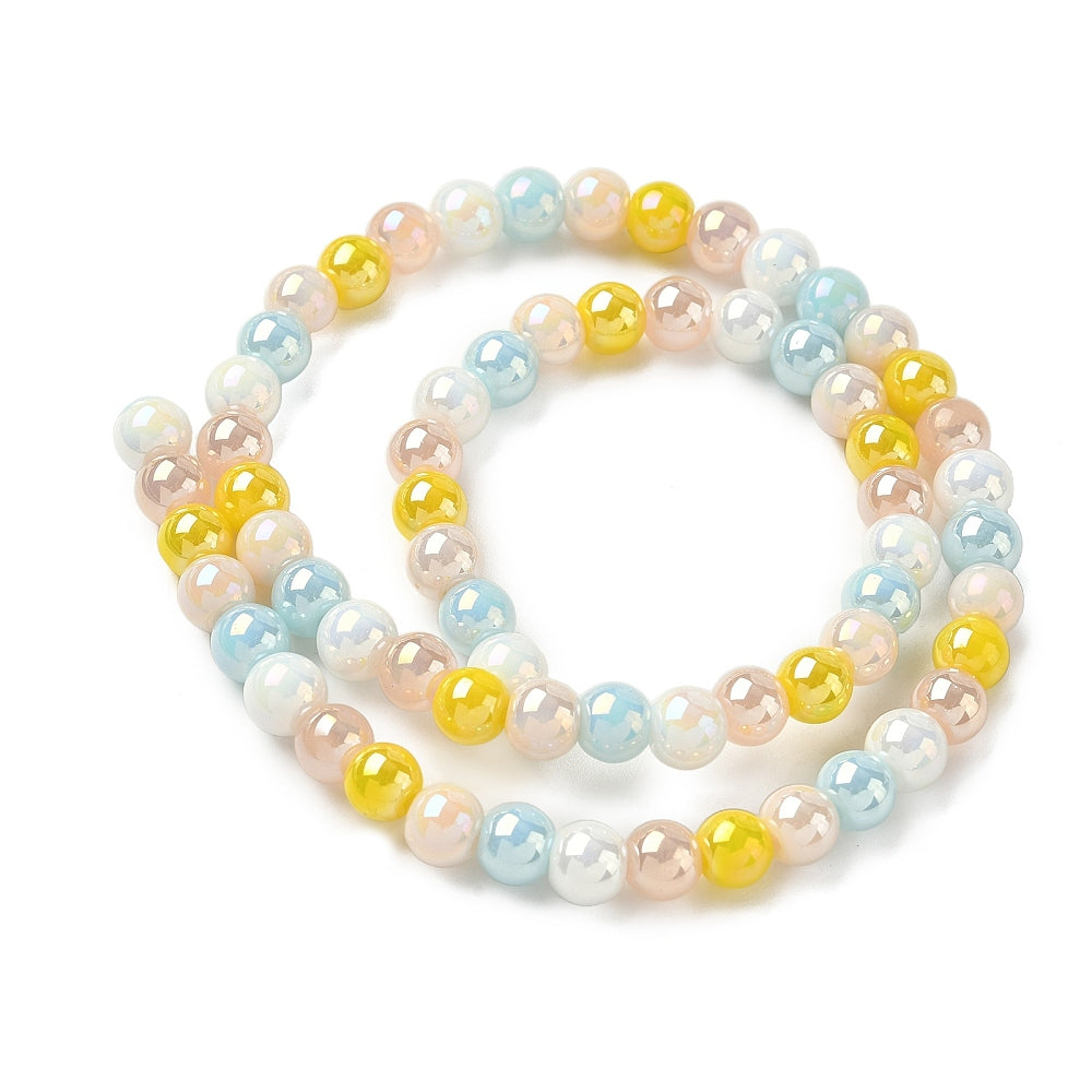 iridescent opaque blue and yellow glass bead strand in swirl design over white surface. 
