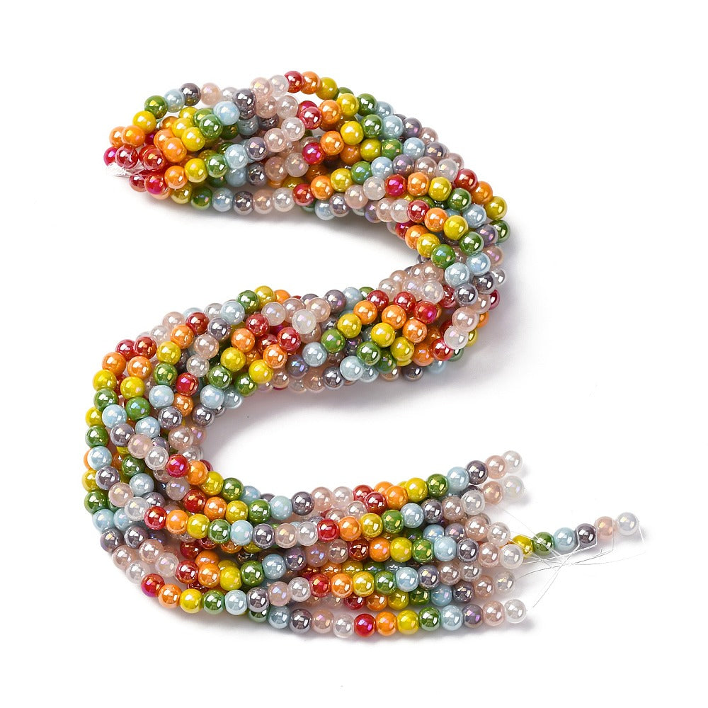 hank of iridescent opaque rainbow glass bead strands twisted over white surface. 