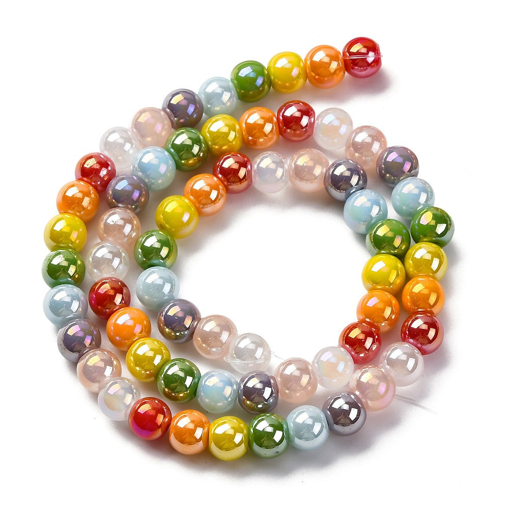 iridescent opaque rainbow glass bead strand in swirl design over white surface. 