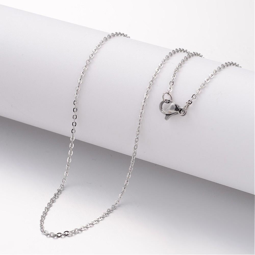 silver tone flat cable chain necklace with lobster claw clasp draped over white cylinder form over white background. 