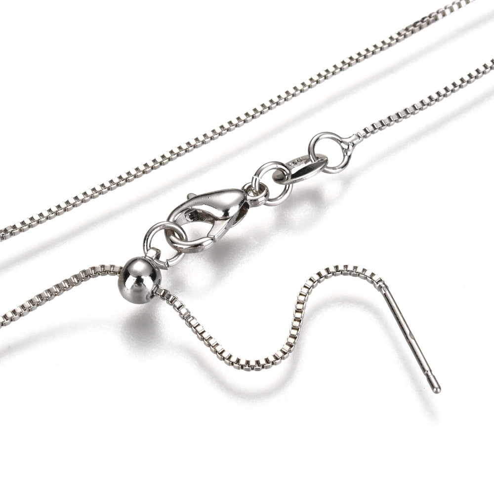 zoomed in sections of silver color adjustable box chain with lobster claw clasp on a white background.