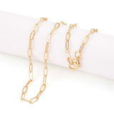 golden small paperclip link necklace with lobster claw clasp on white cylinder over white background.
