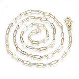 light golden small paperclip link necklace with lobster claw clasp in a swirl pattern over white background. 