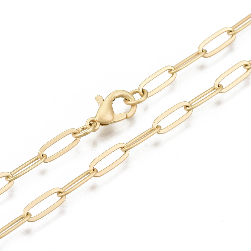 zoomed in sections of matte finished golden medium paperclip link chain with lobster claw clasp on white background. 