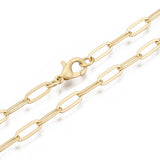 zoomed in sections of matte finished golden medium paperclip link chain with lobster claw clasp on white background. 