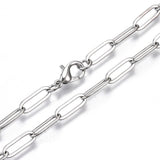 zoomed in section of silver tone large paperclip link chain with lobster claw clasp on white background. 