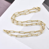 matte finished golden medium paperclip link chain with lobster claw clasp on white background with grey sections. 