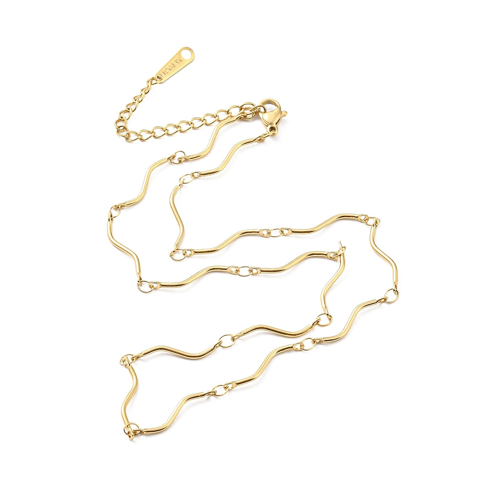 golden wave bar link chain necklace with lobster claw clasp and extender chain over white surface. 