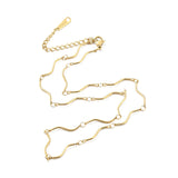 golden wave bar link chain necklace with lobster claw clasp and extender chain over white surface. 