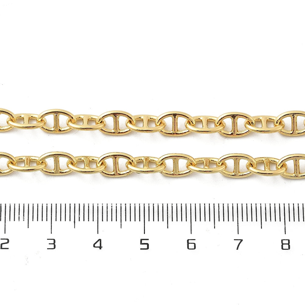zoomed in sections of golden oval mariner link chain necklace displayed above ruler with white background. 