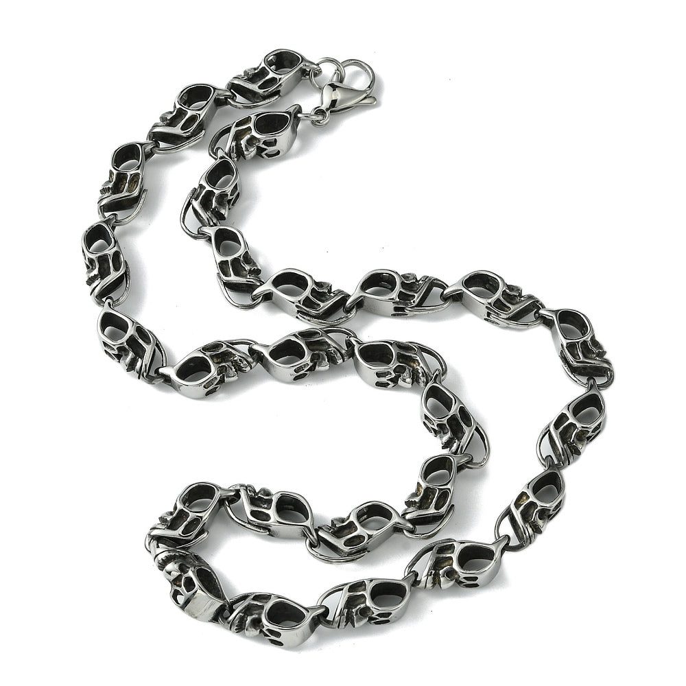 silver tone skull link necklace with lobster claw clasp on white background. 