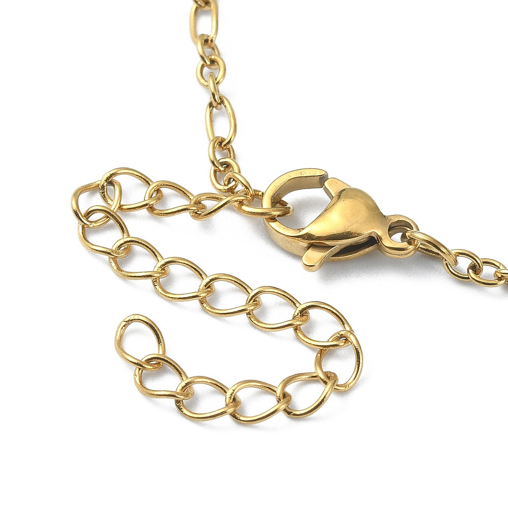 zoomed in golden lobster claw clasp and extender chain on figaro link necklace on white background. 
