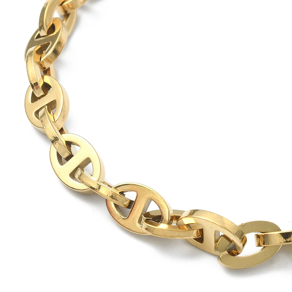 zoomed in section of golden alternating oval and mariner link chain necklace on white background. 