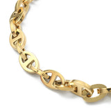 zoomed in section of golden alternating oval and mariner link chain necklace on white background. 