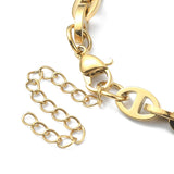 zoomed in section of golden alternating oval and mariner link chain necklace with lobster claw clasp and extender chain on white background. 