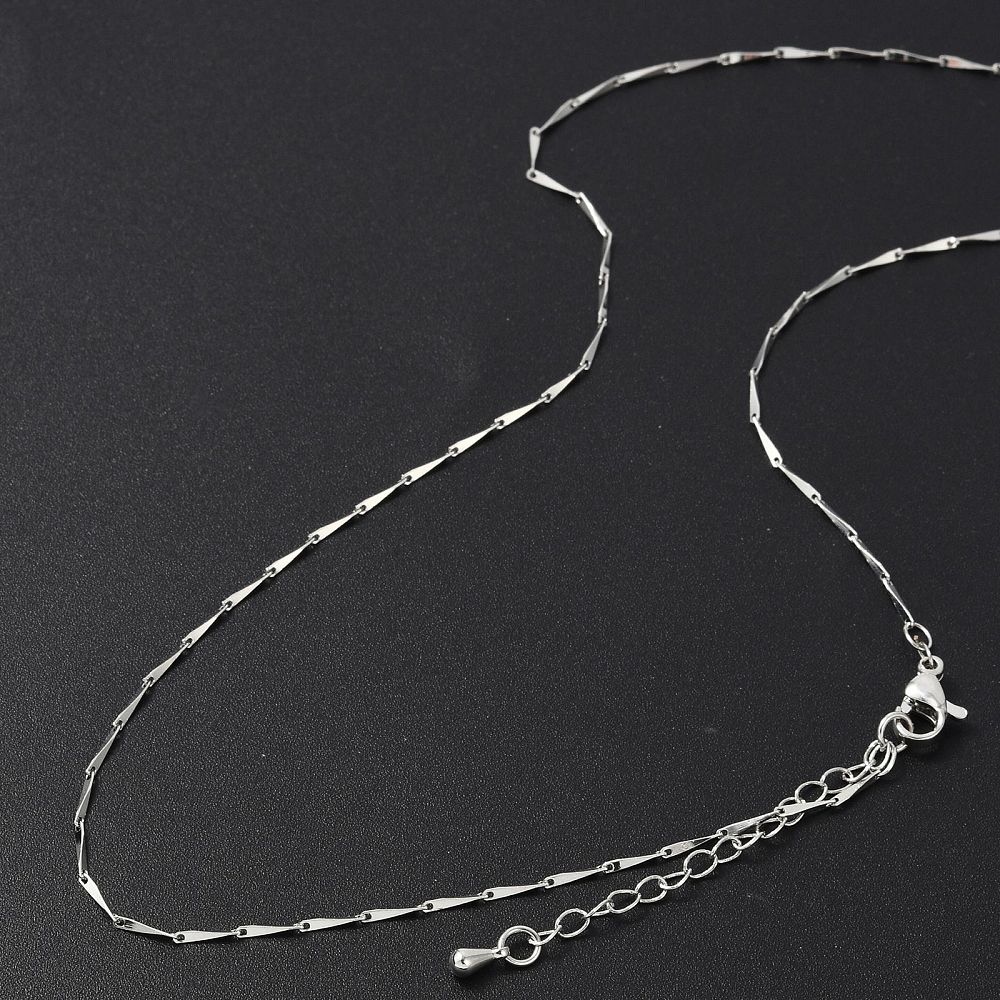 silver tone twisted bar link necklace with lobster claw clasp and extender chain on black background.