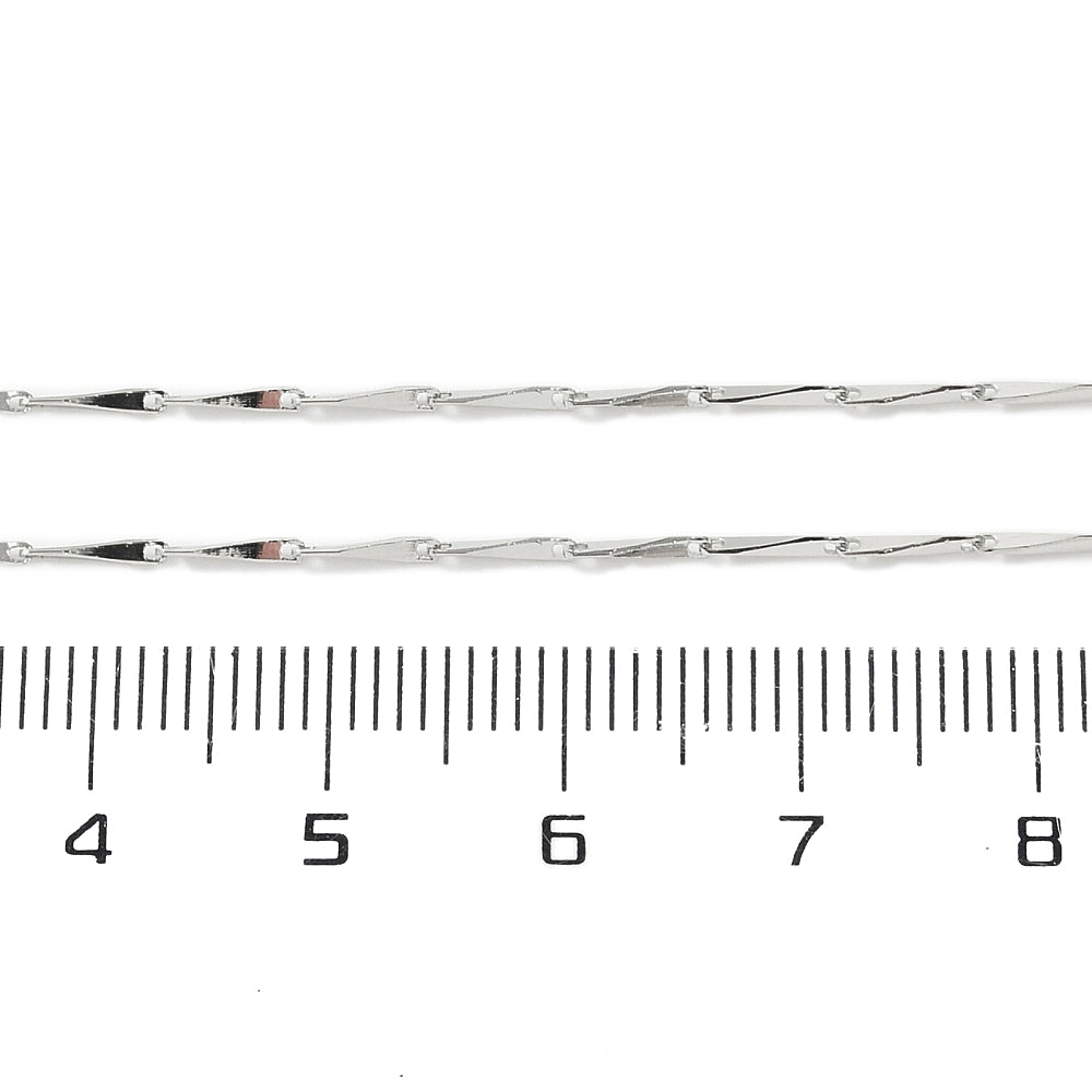 silver tone twisted link chain displayed over ruler on white background. 