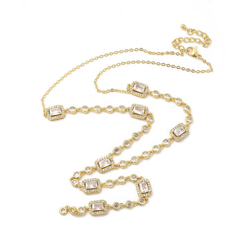 Golden clear rectangle and round stone link lariat Y necklace with lobster claw clasp and extender chain over white surface. 
