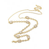 Golden clear rectangle and round stone link lariat Y necklace with lobster claw clasp and extender chain over white surface. 