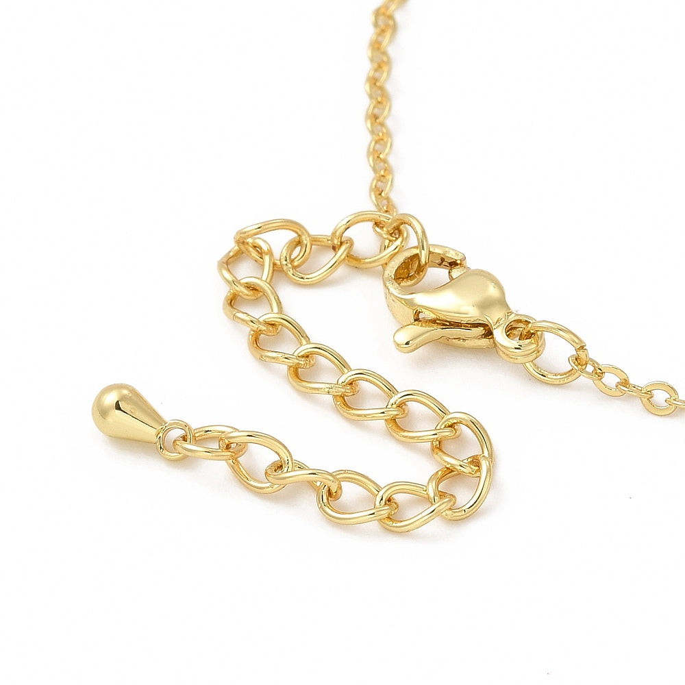 zoomed in golden lobster claw clasp with extender chain over white surface. 