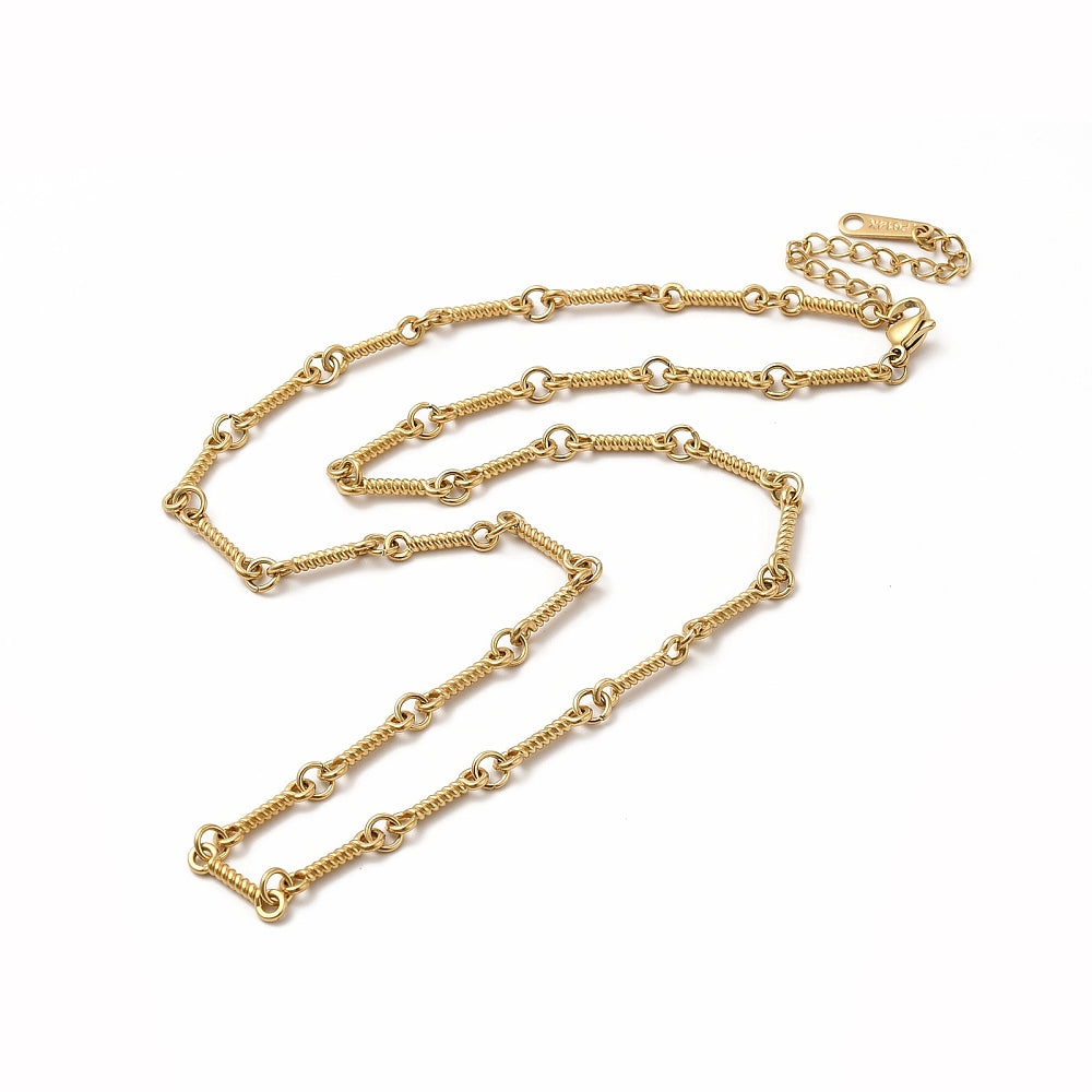 golden twisted bar link chain necklace with lobster claw clasp, extender chain over white background. 