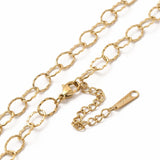 zoomed in sections of golden hammered oval link chain with lobster claw clasp and extender chain over white background. 