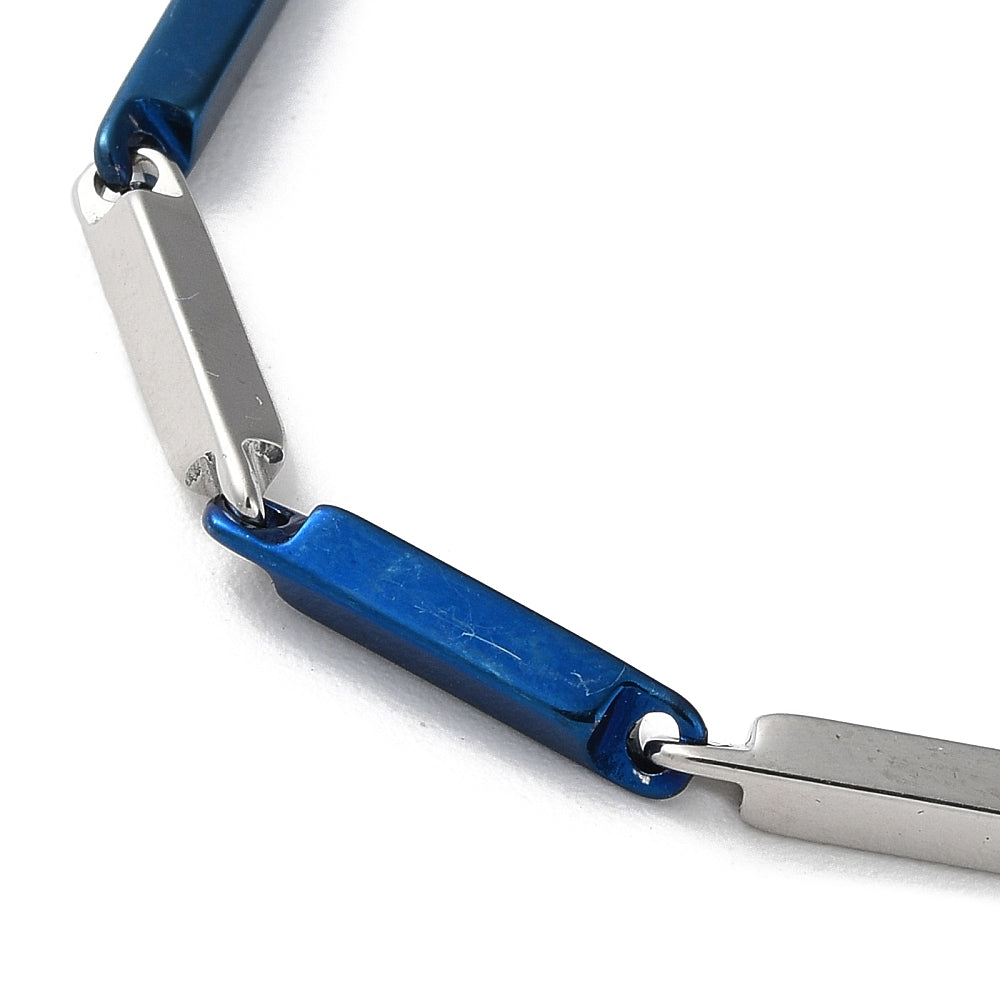 zoomed in section of blue and silver tone bar link chain over white background. 