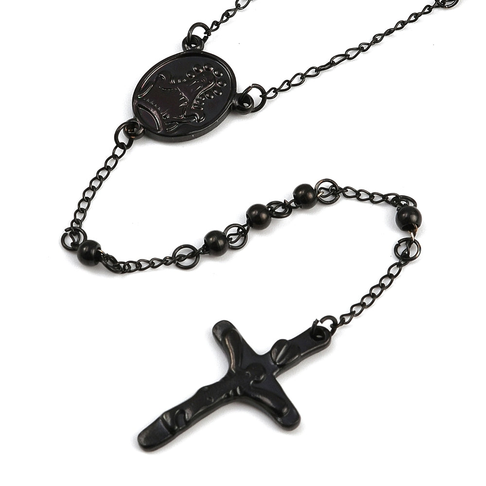 zoomed in front of black oval medal connector and crucifix over white background. 