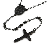 zoomed in back of black oval medal connector and crucifix over white background. 