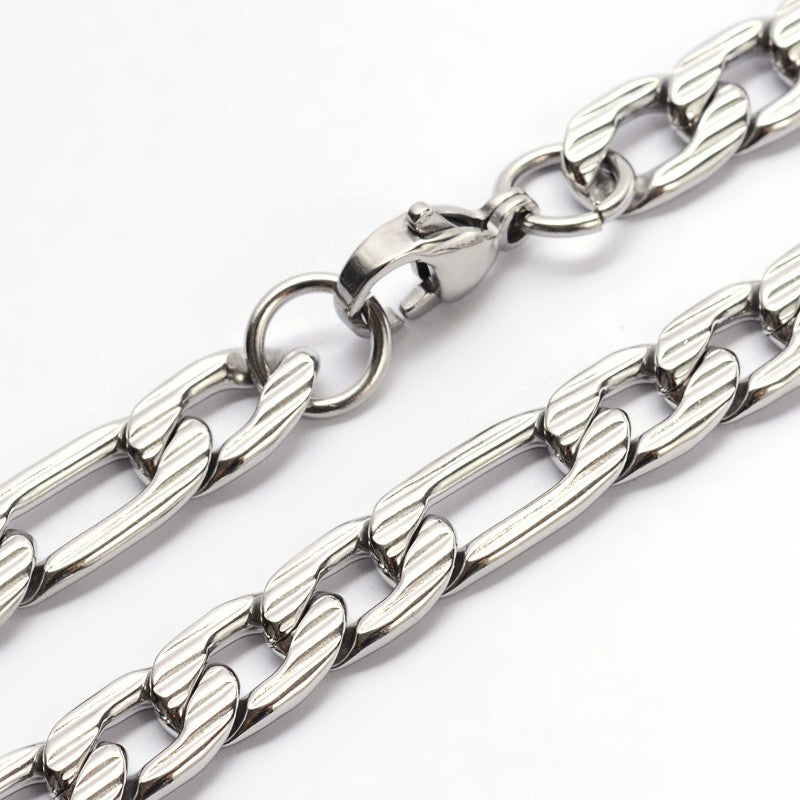 zoomed in sections of silver tone textured Figaro chain on white background. 