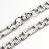 zoomed in sections of silver tone textured Figaro chain on white background. 