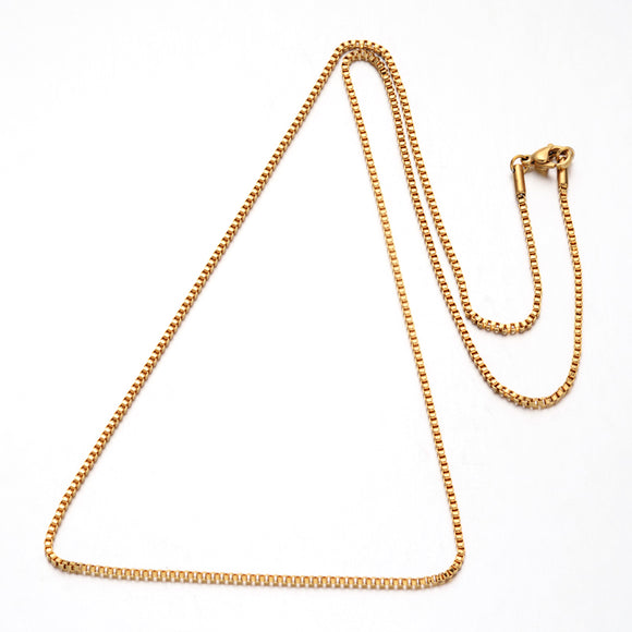 golden box chain necklace with lobster claw clasp over white background. 