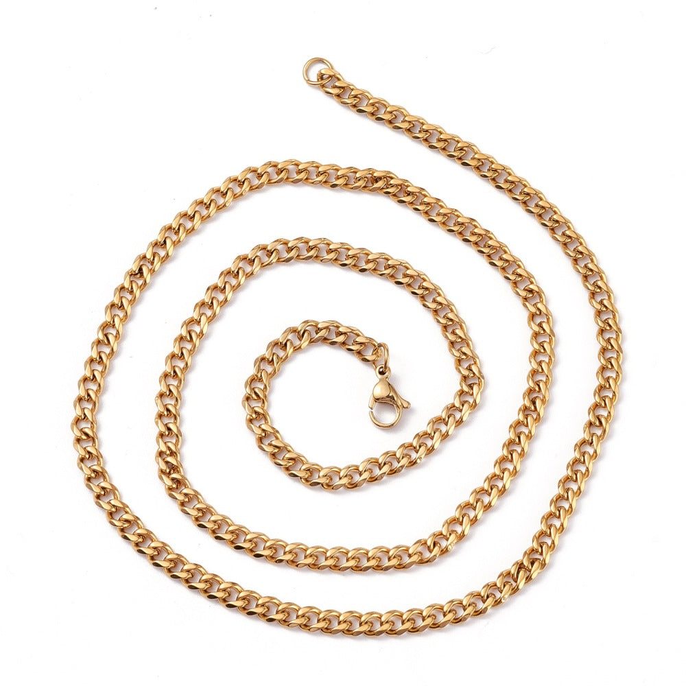 golden small curb chain necklace with lobster claw clasp over white background. 