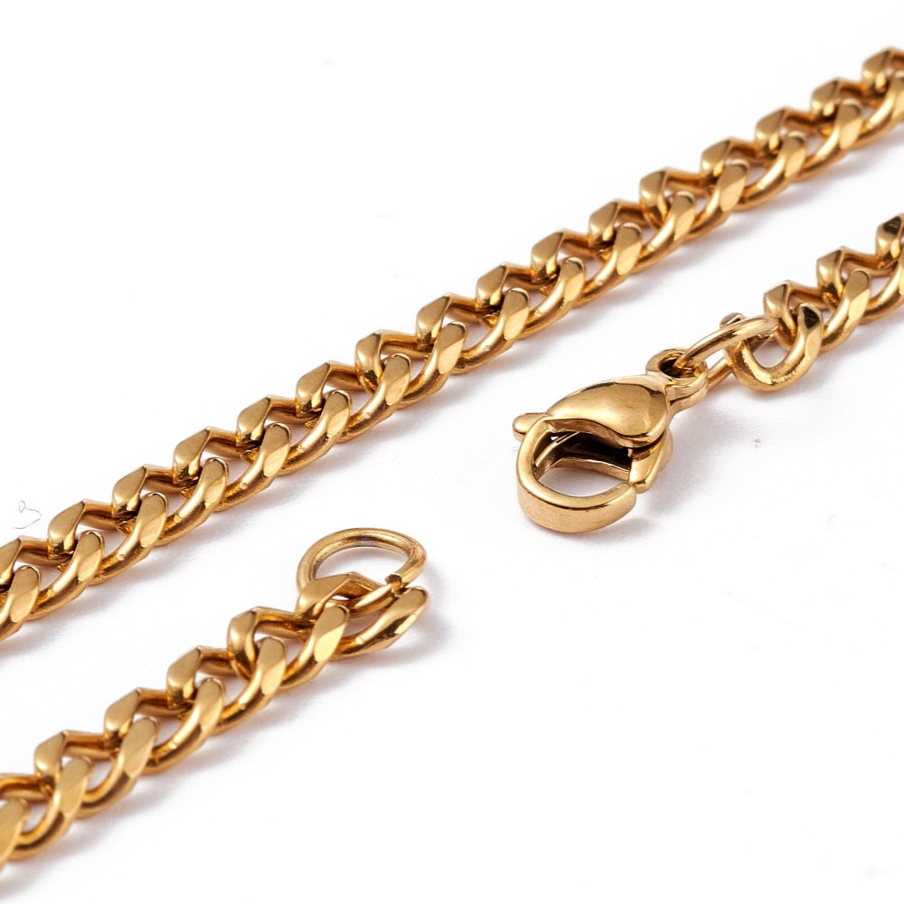 zoomed in sections of golden small curb chain necklace with lobster claw clasp over white background. 