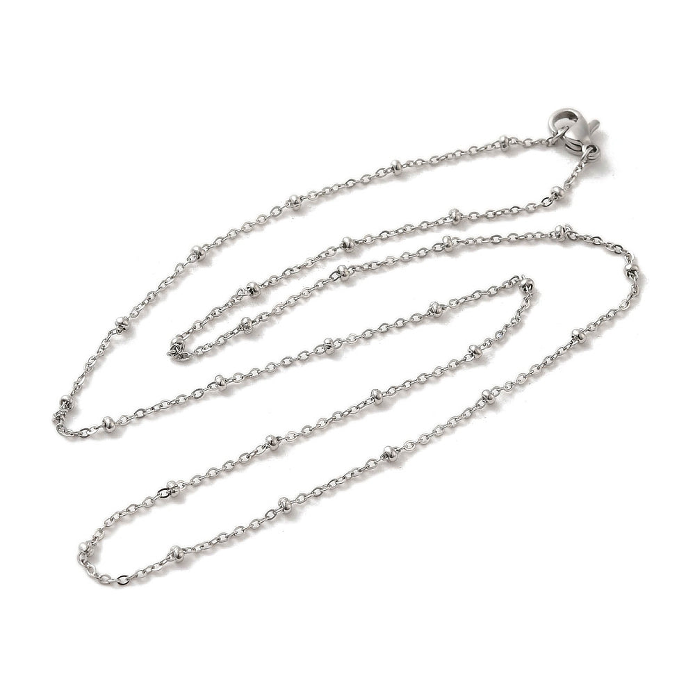 silver tone satellite chain necklace with rondelle beads and lobster claw clasp over white background. 