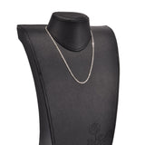 silver tone cable chain displayed on black neck form against white background. 