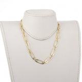 golden safety pin link chain necklace on off white neck form with white background. 