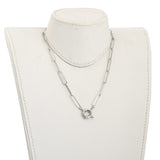 silver tone paperclip chain necklace with large spring ring clasp displayed on off-white neck form against white background. 