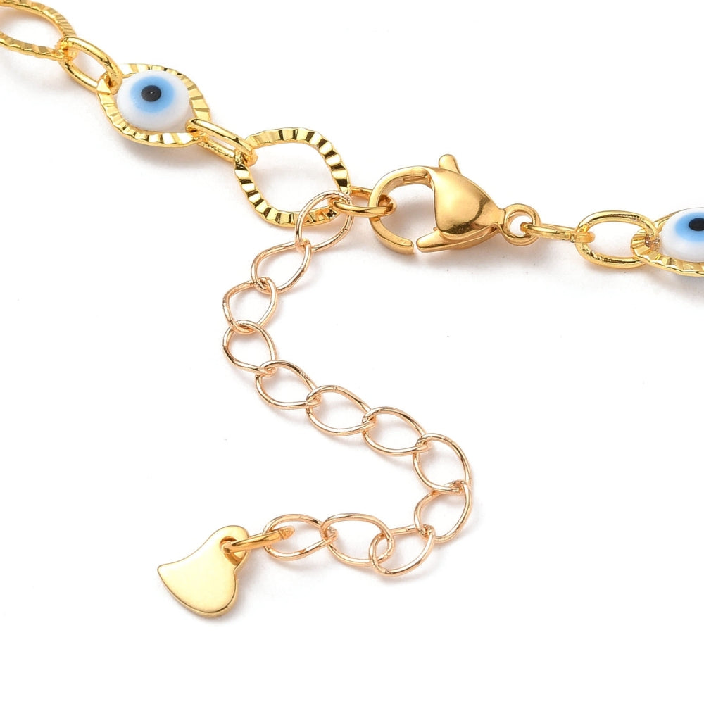 zoomed in section of golden horse eye and evil eye link choker necklace with lobster claw clasp and extender chain over white background. 