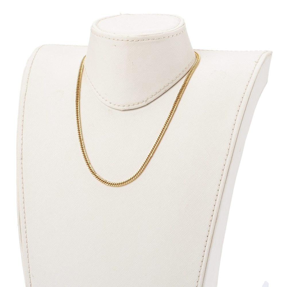 golden small curb chain necklace displayed on cream neck form with white background. 