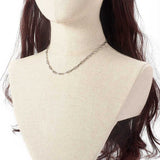 silver tone paperclip chain necklace on a brunette mannequin neck over white background. 