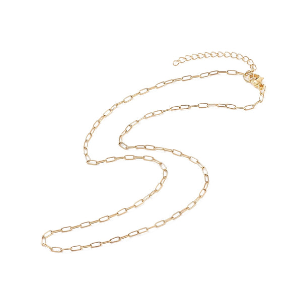 zoomed in sections of small golden paperclip chain with lobster claw clasp and extender chain over white background. 