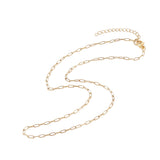 zoomed in sections of small golden paperclip chain with lobster claw clasp and extender chain over white background. 