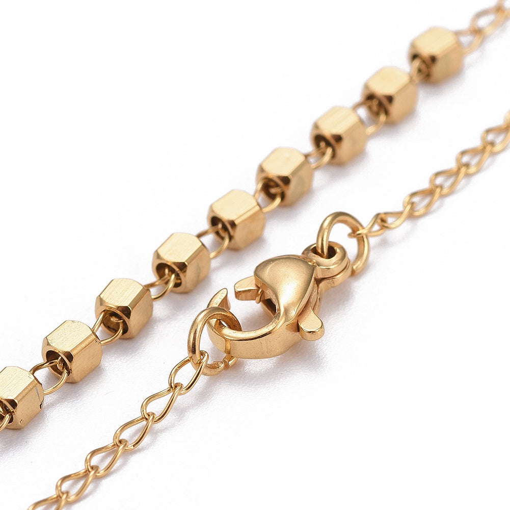zoomed in sections of golden rosary necklace with cube rosary beads and a lobster claw clasp over white background. 
