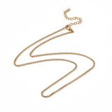 golden Rolo chain necklace with lobster claw clasp and extender chain over white background. 
