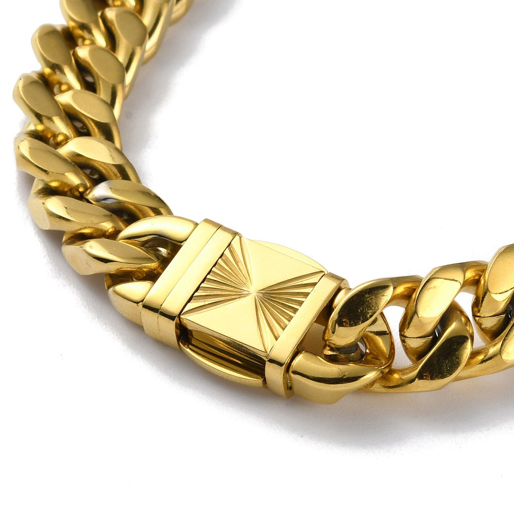 zoomed in section of golden extra large curb link necklace with swirl decorative box clasp on white background. 
