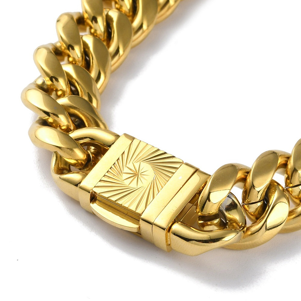 zoomed in section of golden extra large curb link necklace with diamond cut sunburst decorative box clasp on white background. 
