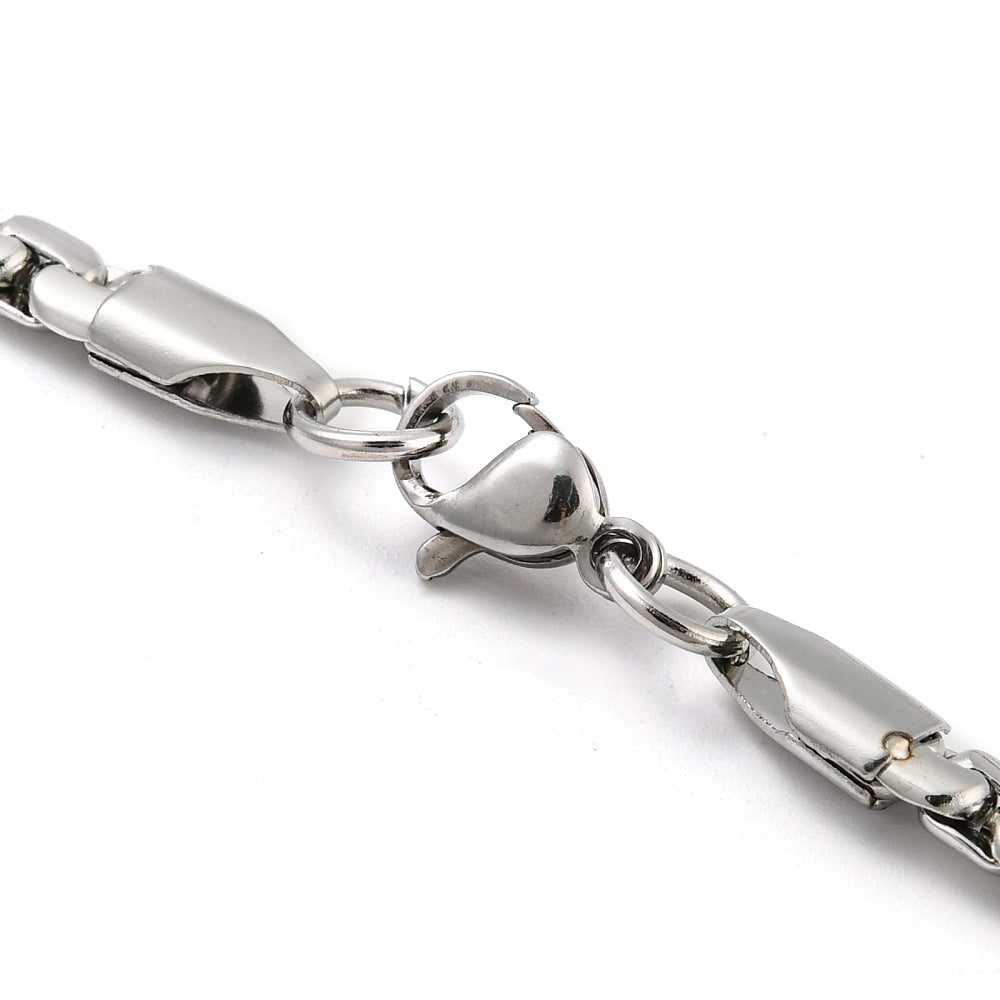 zoomed in section of silver tone flat box chain with lobster claw clasp on white background. 