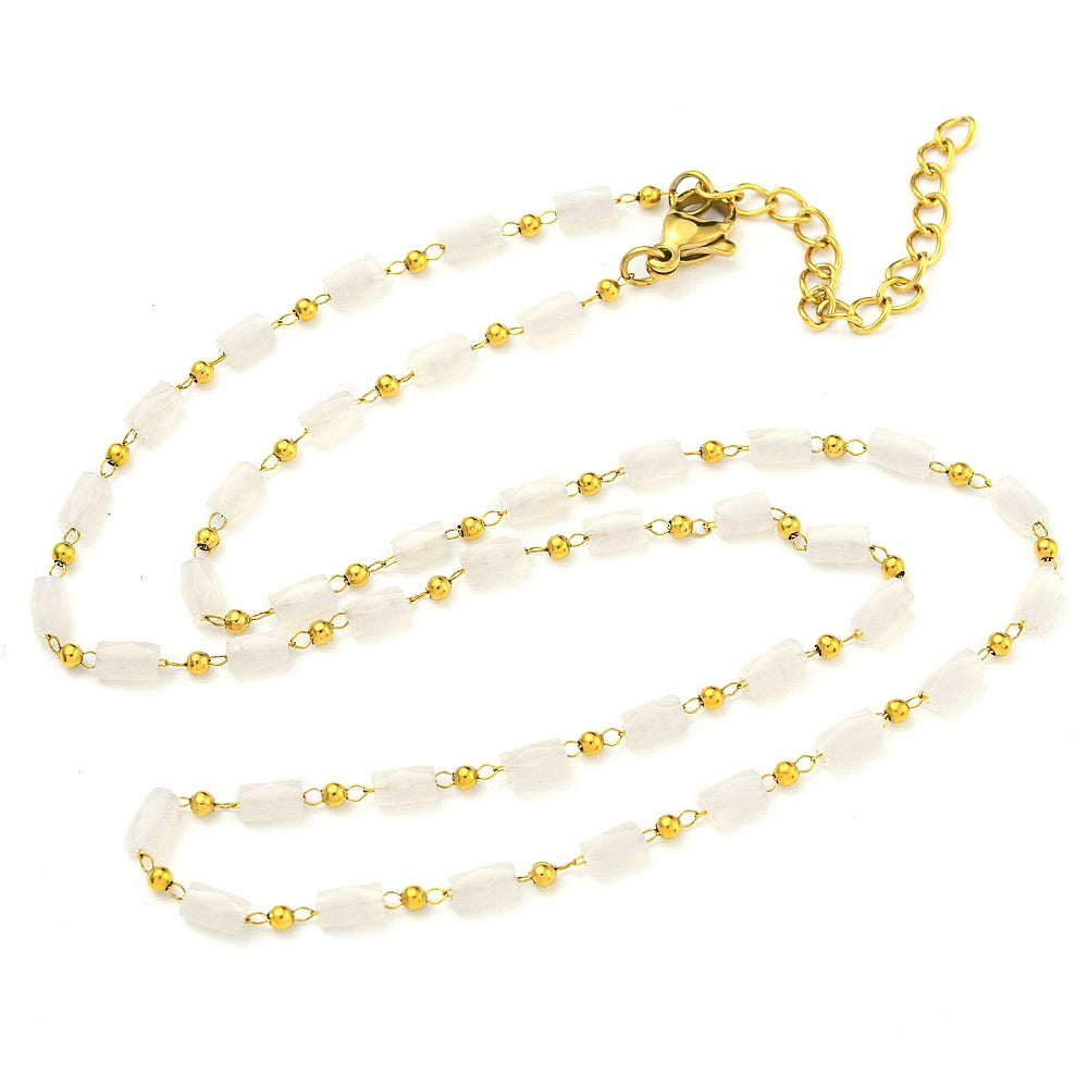 white glass column link chain necklace with golden lobster claw clasp and extender chain on white background. 
