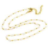 white glass column link chain necklace with golden lobster claw clasp and extender chain on white background. 